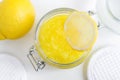 Homemade lemon facial mask exfoliating sugar scrub in the glass jar. DIY citrus beauty treatment and spa recipe. Royalty Free Stock Photo