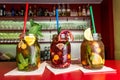 Homemade lemonade ice tea colorful icetea drink with fresh sweet fruits mint leaves in glass on the rocks with straw