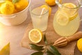 Homemade lemonade on kitchen table with basket full of lemons Royalty Free Stock Photo