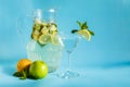 Homemade lemonade with lemon, mint and apple on a blue background Royalty Free Stock Photo