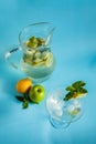 Homemade lemonade with lemon, mint and apple on a blue background Royalty Free Stock Photo