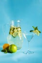 Homemade lemonade with lemon, mint and apple on a blue background Royalty Free Stock Photo