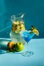 Homemade lemonade with lemon, mint and apple on a blue background Royalty Free Stock Photo