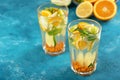 Homemade lemonade with lemon, orange, sea buckthorn and mint in glasses on blue background Royalty Free Stock Photo