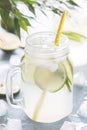 Homemade Lemonade with Lime in a Mason Jar on Blue Background Tasty Citrus Infused Water Summer Beverage Vertical