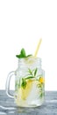Homemade lemonade with lemon, mint, rosemary in a mason jar on concrete background. Royalty Free Stock Photo