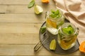 Homemade lemonade with lime, mint in a mason jar on a wooden rustic table. Summer drinks. Copy space