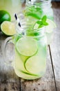 Homemade lemonade with lime, mint in a mason jar on a wooden table Royalty Free Stock Photo