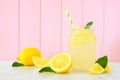 Lemonade in a mason jar glass with lemons, side view against pink wood Royalty Free Stock Photo