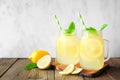 Homemade lemonade in mason jar glasses with lemons