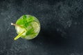 Homemade lemonade or mojito cocktail with lime, mint and ice cubes in a glass on a dark stone table. Fresh summer drink Royalty Free Stock Photo