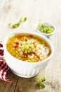 Homemade lentil soup with tomatoes in a white bowl