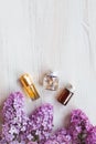 Homemade lilac cosmetics, care products, Small jars with infusion water of lilac, essential oil,