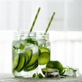 Homemade lime lemonade with cucumber, rosemary and ice, white background. Cold beverage for hot summer day. Copyspace Royalty Free Stock Photo