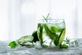 Homemade lime lemonade with cucumber, rosemary and ice, white background. Cold beverage for hot summer day. Copyspace Royalty Free Stock Photo