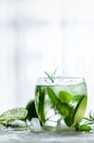 Homemade lime lemonade with cucumber, rosemary and ice, white background. Cold beverage for hot summer day. Copyspace Royalty Free Stock Photo