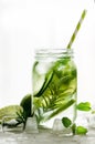 Homemade lime lemonade with cucumber, rosemary and ice, white background. Cold beverage for hot summer day. Copyspace Royalty Free Stock Photo