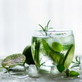 Homemade lime lemonade with cucumber, rosemary and ice, white background. Cold beverage for hot summer day. Copyspace Royalty Free Stock Photo