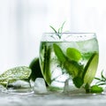 Homemade lime lemonade with cucumber, rosemary and ice, white background. Cold beverage for hot summer day. Copyspace Royalty Free Stock Photo