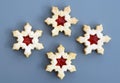 Homemade linzer cookies in a shape of snowflakes filled with strawberry jam Royalty Free Stock Photo