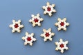 Homemade linzer cookies in a shape of snowflakes filled with strawberry jam Royalty Free Stock Photo