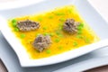 homemade liver dumplings in chicken soup with carrots and peas Royalty Free Stock Photo