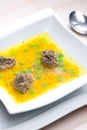 homemade liver dumplings in chicken soup with carrots and peas Royalty Free Stock Photo