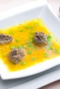 homemade liver dumplings in chicken soup with carrots and peas Royalty Free Stock Photo