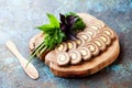 Homemade liver roll pate with butter on wooden cutting board