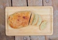 Homemade loaf of bread on wooden board