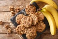 Homemade low-calorie banana cookies with oatmeal and walnuts close-up on a slate board. Horizontal top view Royalty Free Stock Photo