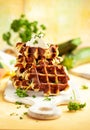 Homemade low carb zucchini waffles on white wooden board on yellow background. Concept of keto diet food