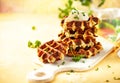 Homemade low carb zucchini waffles on white wooden board on yellow background. Concept of keto diet food