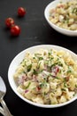 Homemade Macaroni Salad in a white bowl on a black background Royalty Free Stock Photo