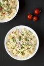 Homemade Macaroni Salad in a white bowl on a black background, top view. Flat lay, overhead, from above Royalty Free Stock Photo