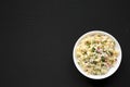 Homemade Macaroni Salad in a white bowl on a black background, top view. Flat lay, overhead, from above. Copy space Royalty Free Stock Photo