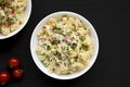 Homemade Macaroni Salad in a white bowl on a black background, top view. Flat lay, overhead, from above. Copy space Royalty Free Stock Photo