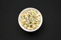 Homemade Macaroni Salad in a white bowl on a black background, top view. Flat lay, overhead, from above Royalty Free Stock Photo