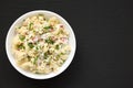 Homemade Macaroni Salad in a white bowl on a black surface, top view. Flat lay, overhead, from above. Copy space Royalty Free Stock Photo