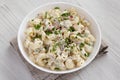 Homemade Macaroni Salad in a white bowl on a white wooden background, side view. Close-up Royalty Free Stock Photo