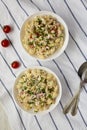 Homemade Macaroni Salad in white bowls, top view. Flat lay, overhead, from above Royalty Free Stock Photo