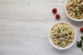 Homemade Macaroni Salad in white bowls on a white wooden background, top view. Flat lay, overhead, from above. Copy space Royalty Free Stock Photo
