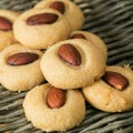 Homemade Macaroons with almond nuts closeup stacked on the wicker background. Square picture