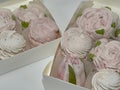 Homemade marshmallows in open boxes. Marshmallow flowers and classic marshmallows.