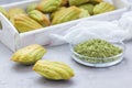 Homemade matcha green tea madeleines on the table and in wooden tray Royalty Free Stock Photo