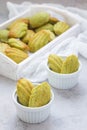 Homemade matcha green tea madeleines on the table and in wooden tray