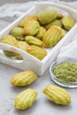 Homemade matcha green tea madeleines on the table and in wooden tray Royalty Free Stock Photo