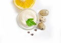 Homemade mayonnaise, sauce condiment quail eggs, lemon on white background