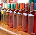 Homemade mead bottles on the shelf of an outdoor market. It is also known as honey wine