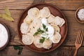 Homemade meat dumplings - russian pelmeni with sour cream